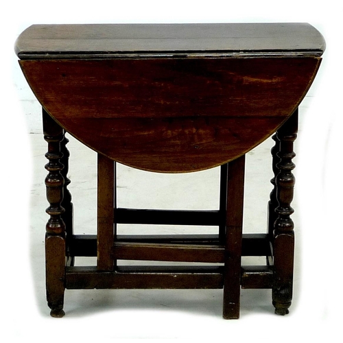 304 - A 17th century oak drop leaf table, with oval top, single drawer, kick leg action, 73 by 86.5 by 68c... 