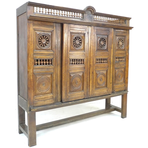 307 - A French oak cupboard, 19th century and later, with carved and baluster detail, bears carved date '1... 