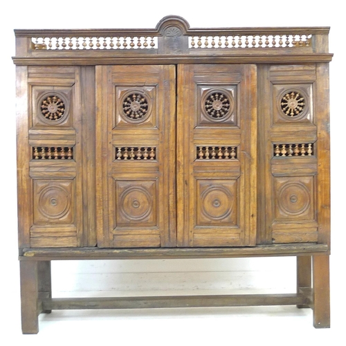 307 - A French oak cupboard, 19th century and later, with carved and baluster detail, bears carved date '1... 