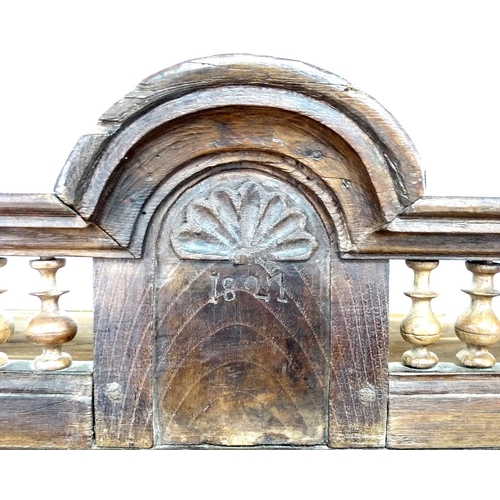 307 - A French oak cupboard, 19th century and later, with carved and baluster detail, bears carved date '1... 