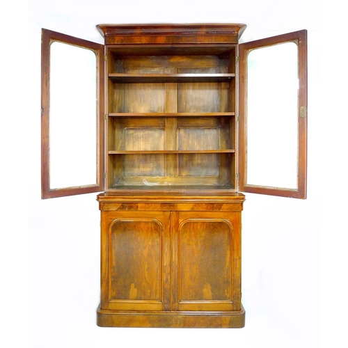 308 - A Victorian mahogany and walnut veneered bookcase, twin glazed doors enclosing three shelves, twin a... 