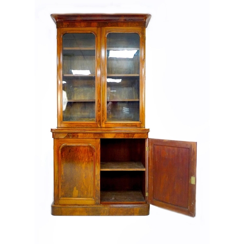 308 - A Victorian mahogany and walnut veneered bookcase, twin glazed doors enclosing three shelves, twin a... 