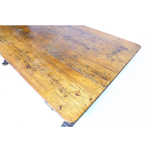 310 - A 19th century stained pine refectory table, with good patination, and X frame end supports, approxi... 