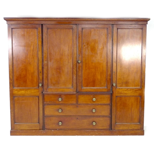 313 - A Victorian mahogany compactum wardrobe, with two full length panelled doors enclosing hanging space... 