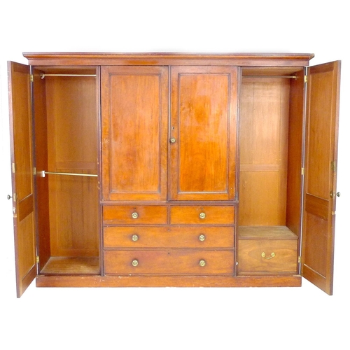 313 - A Victorian mahogany compactum wardrobe, with two full length panelled doors enclosing hanging space... 