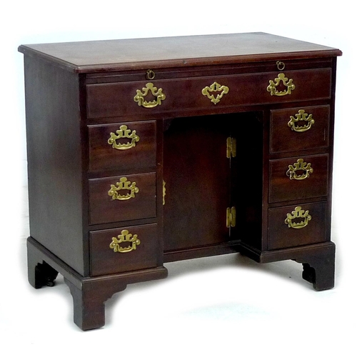 315 - A George III mahogany kneehole desk, with pull out slide, long drawer over central recess with cupbo... 