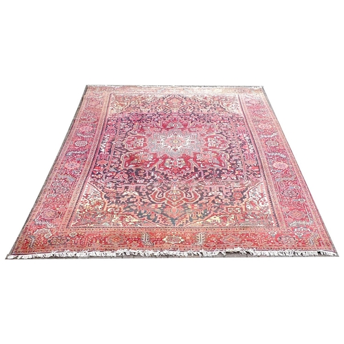 316 - A Heriz carpet with red ground, central cream, grey and red star shaped medallion, dark blue ground ... 