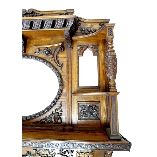 319 - An impressive mid 19th century oak fire surround, with an oval overmantel mirror and two smaller sha... 