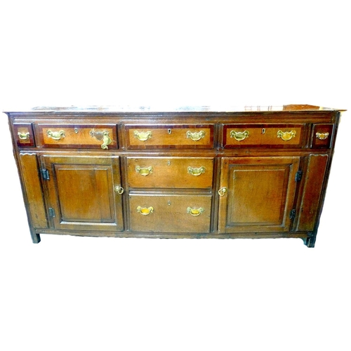 321 - A Georgian oak Lancaster type chest, with various later alterations, five crossbanded drawers over t... 