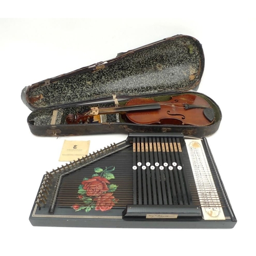 65 - A twelve bar Rosetti, German autoharp, painted black with roses to the board, 51 by 32cm, together w... 