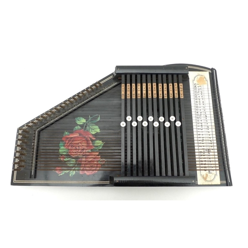 65 - A twelve bar Rosetti, German autoharp, painted black with roses to the board, 51 by 32cm, together w... 