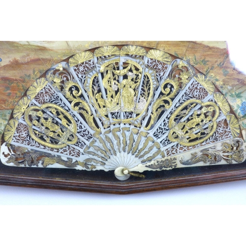 71 - A French or Italian gouache, paper and ivory mounted fan, mid 18th century, the leaf painted with a ... 
