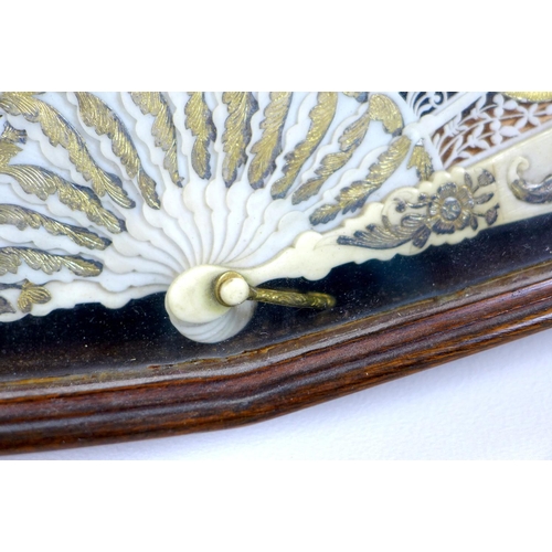71 - A French or Italian gouache, paper and ivory mounted fan, mid 18th century, the leaf painted with a ... 