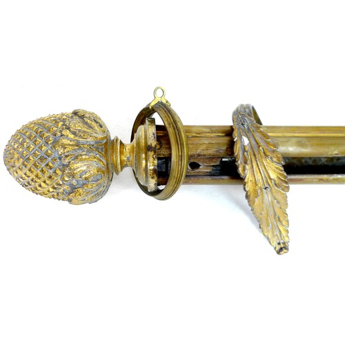 259 - A group of brass curtain rails and curtains, including a pair of rails with pineapple finials and le... 