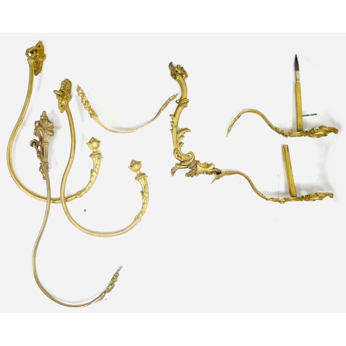 259 - A group of brass curtain rails and curtains, including a pair of rails with pineapple finials and le... 