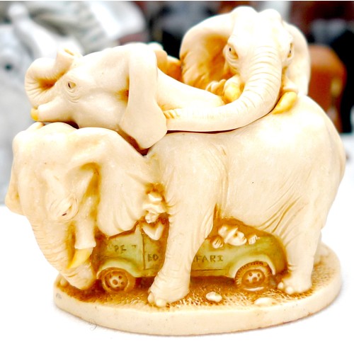 24 - A large collection of over sixty pachyderm figurines, including a white ceramic elephant with indist... 