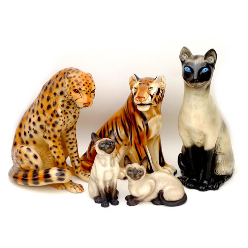 22 - A group of five china feline figurines, comprising three Siamese cats, largest, a/f, 22 by 16 by 42.... 