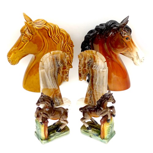 14 - A collection of six equine ornaments, comprising two horse head busts, the largest, treacle glazed, ... 