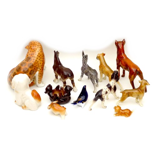 26 - A group of twelve West German and Russian china animal figurines, including dogs, bears, and a leopa... 