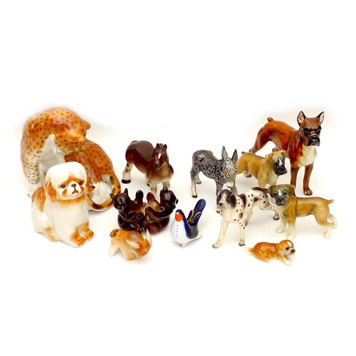 26 - A group of twelve West German and Russian china animal figurines, including dogs, bears, and a leopa... 