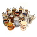 A collection of modern drinking steins, with moulded and printed decoration, most with metal hinged ... 