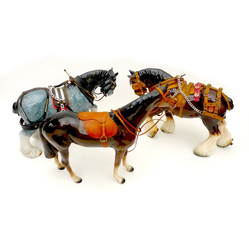 11 - A group of three china animal figurines, comprising two modelled as shire horses, and one as a raceh... 