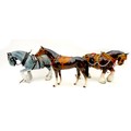 A group of three china animal figurines, comprising two modelled as shire horses, and one as a raceh... 