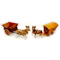 A group of china animal figurines, comprising two modelled as horses pulling a wooden cart and a car... 
