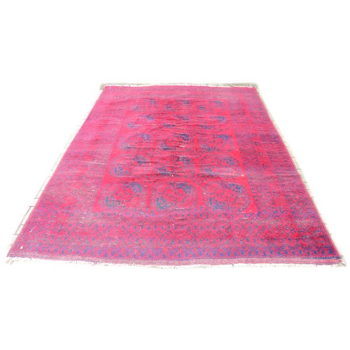 341 - A large Tekke rug with dark red and blue grounds, decorated with three rows of five elephants foot g... 