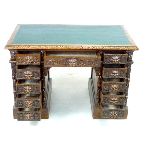 343 - An early 20th century oak twin pedestal desk, three frieze drawers, each pedestal with four drawers,... 