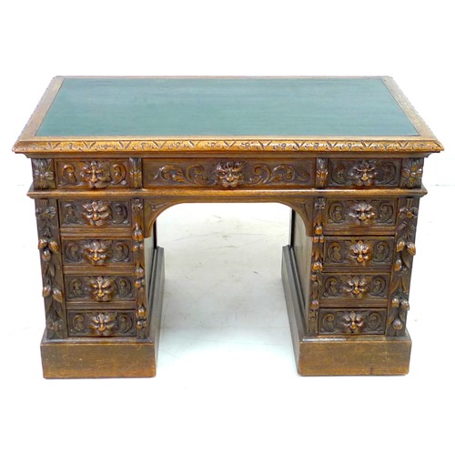 343 - An early 20th century oak twin pedestal desk, three frieze drawers, each pedestal with four drawers,... 