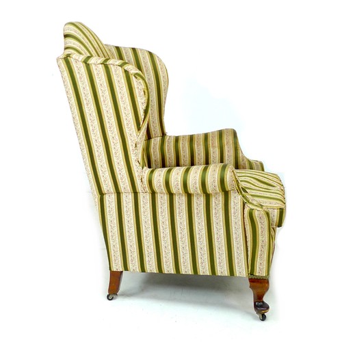 344 - An early 20th century Queen Anne style wing armchair, upholstered in striped dark green and gold flo... 