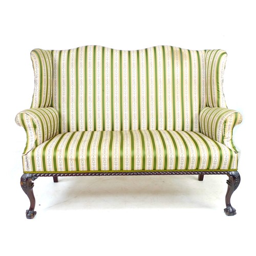 353 - A Victorian wing settee, two seater, high back, upholstered in striped dark green and gold floral em... 