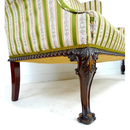 353 - A Victorian wing settee, two seater, high back, upholstered in striped dark green and gold floral em... 