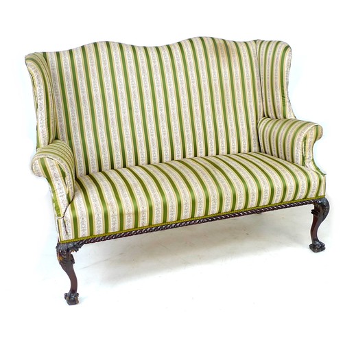 353 - A Victorian wing settee, two seater, high back, upholstered in striped dark green and gold floral em... 