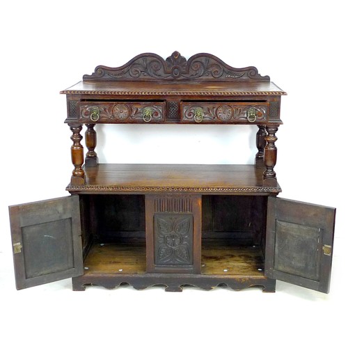 345 - A late Victorian oak buffet, with carved decoration, upper tier with drawers, lower section with cup... 