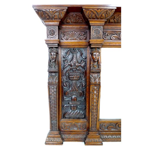 332 - A carved oak overmantel mirror, the bevelled rectangular plate flanked by carved panels and four bus... 