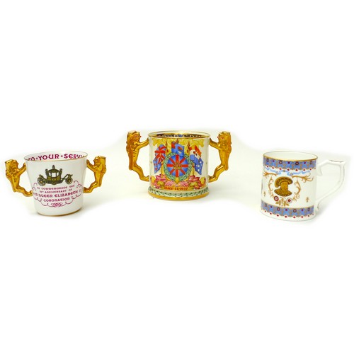 28 - A group of three commemorative cups, comprising a Paragon limited edition loving cup, with lion hand... 