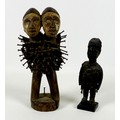 A 20th century double headed African figure, with carved skull caps, white painted faces and the bod... 