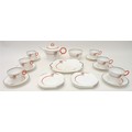 An Art Deco Shelley part tea service, decorated with an abstract design in orange and grey against a... 
