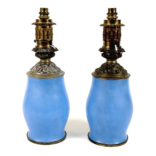 141 - A pair of Sevres style table lamps, 19th century, each porcelain base decorated with an oval reserve... 