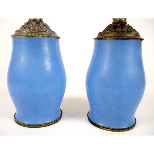 141 - A pair of Sevres style table lamps, 19th century, each porcelain base decorated with an oval reserve... 