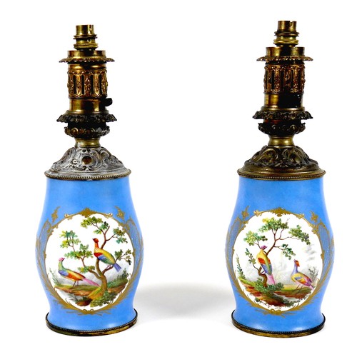 141 - A pair of Sevres style table lamps, 19th century, each porcelain base decorated with an oval reserve... 