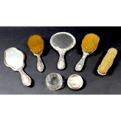 25 - A group of six Victorian and Edwardian silver backed dressing table items, comprising a silver lidde... 