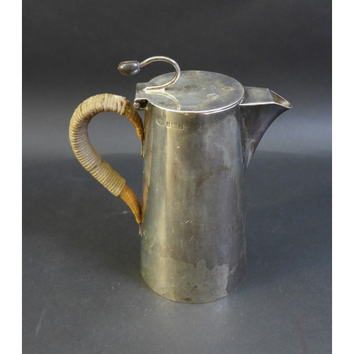 79 - A George V and VI silver coffee pot and hot water pot, the near pair both with flying coffee bean ti... 