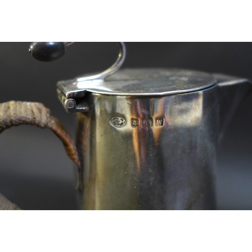 79 - A George V and VI silver coffee pot and hot water pot, the near pair both with flying coffee bean ti... 