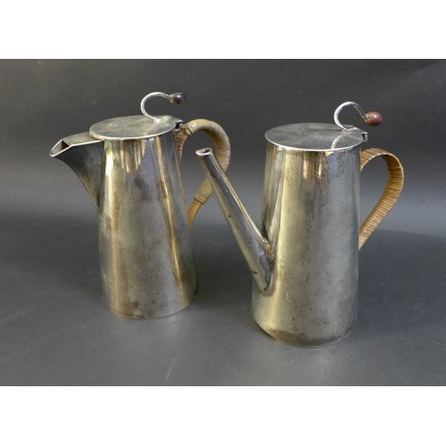 79 - A George V and VI silver coffee pot and hot water pot, the near pair both with flying coffee bean ti... 