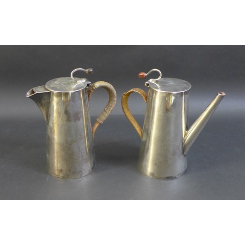 79 - A George V and VI silver coffee pot and hot water pot, the near pair both with flying coffee bean ti... 