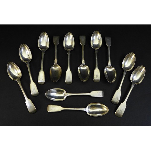 80 - A set of twelve Victorian silver dessert spoons, fiddle pattern, the terminals engraved with the ini... 