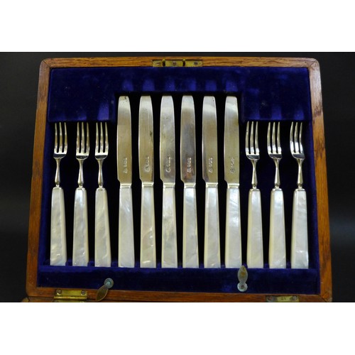 27 - A set of twelve Edwardian silver bladed fruit of dessert knives and forks, all with carved mother of... 